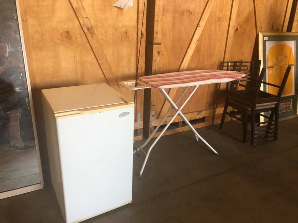 A Room With A Refrigerator And An Ironing Board In The Storage Warehouse — Dawson Moving & Storage NQ in Townsville, QLD