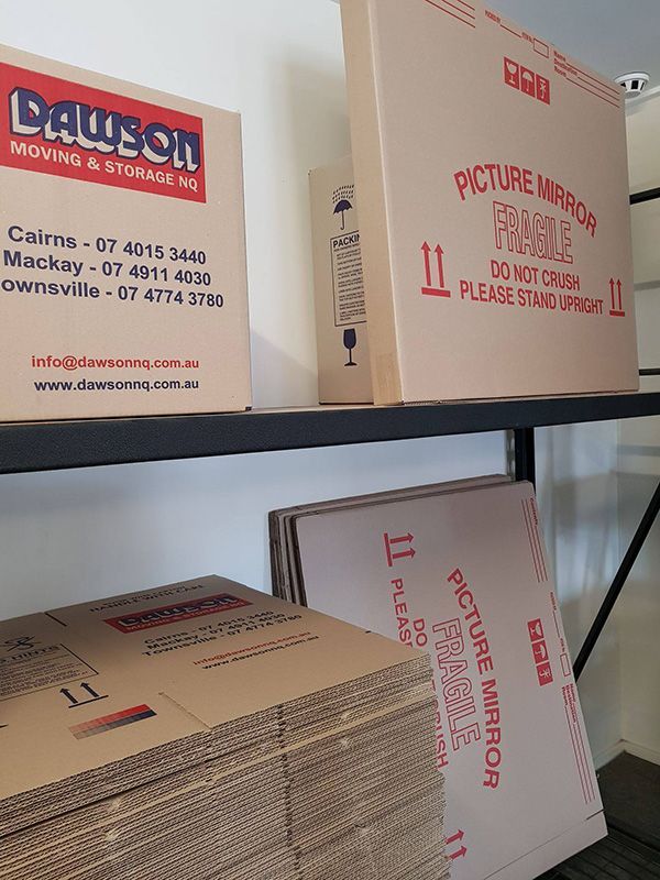 A Shelf Filled With Cardboard Boxes And A Picture Mirror Fragile — Dawson Moving & Storage NQ in Mount St John, QLD