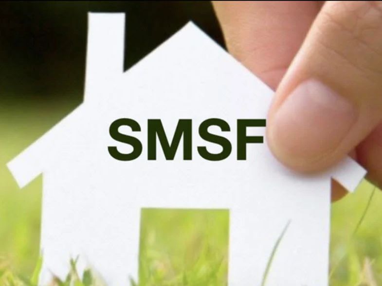 Hand holding a white paper house with