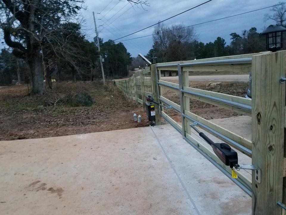 A wooden gate in Columbus Ga with a motor attached to it