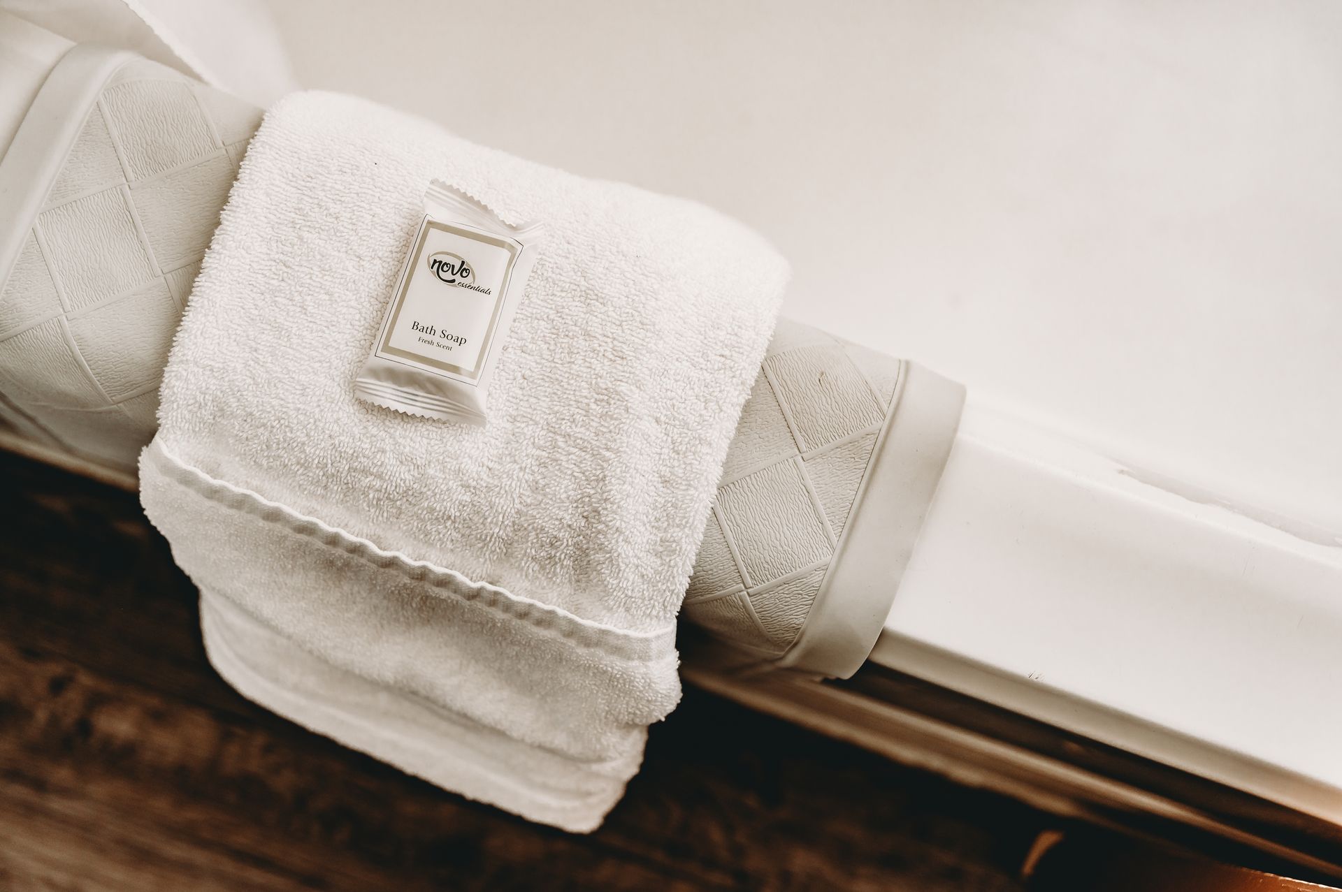 White rolled towel with a small label on a white surface.