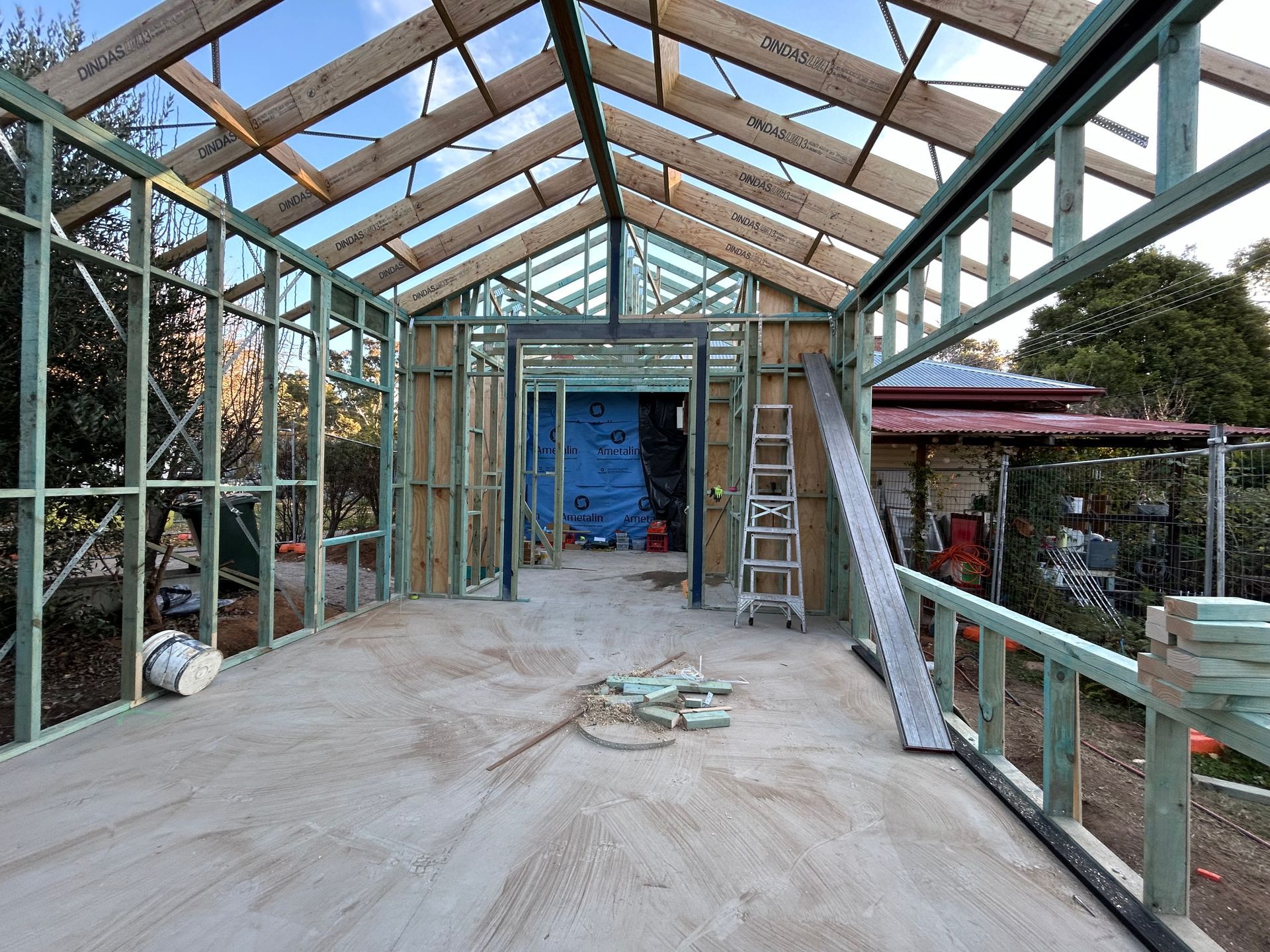 Interior view of a building under construction, with wooden framework and a concrete floor. — Straight up Building Projects in Holt, ACT