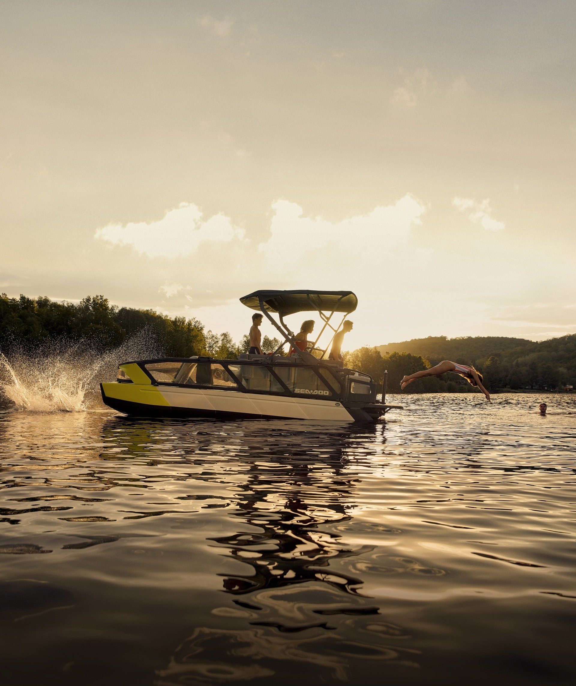 group of 4 in boat on lake with sunset