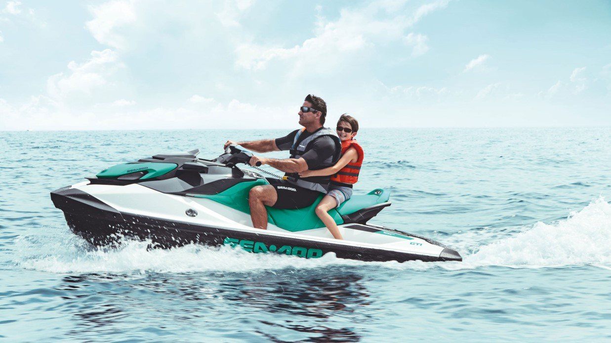 Father and son riding a jet ski