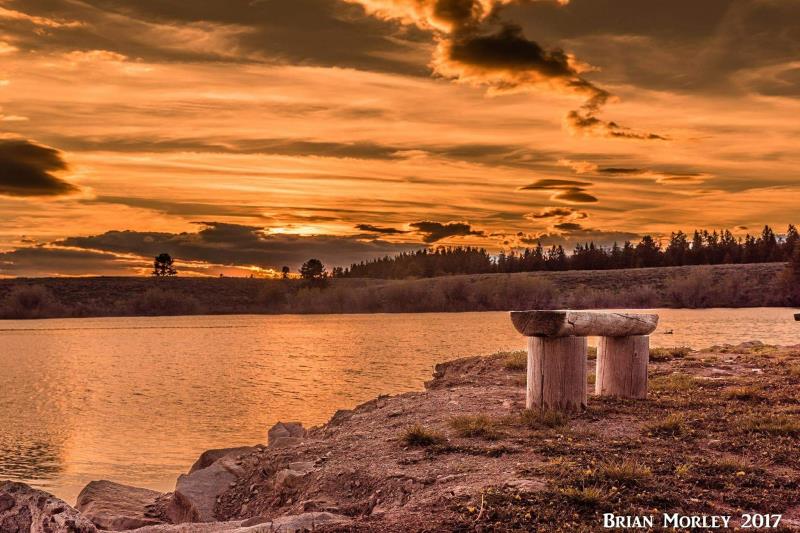 A wooden bench beside a lake