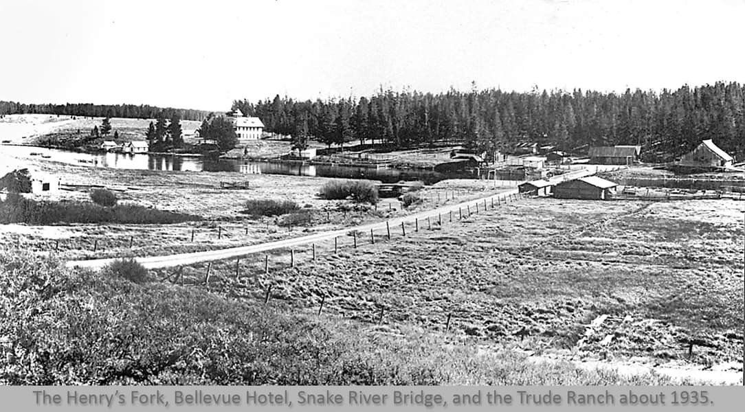 black and white picture of river and cabins