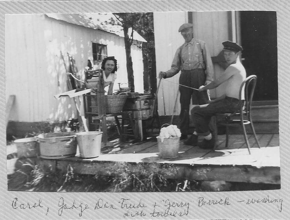 black and white woman and 2 men doing laundry outside