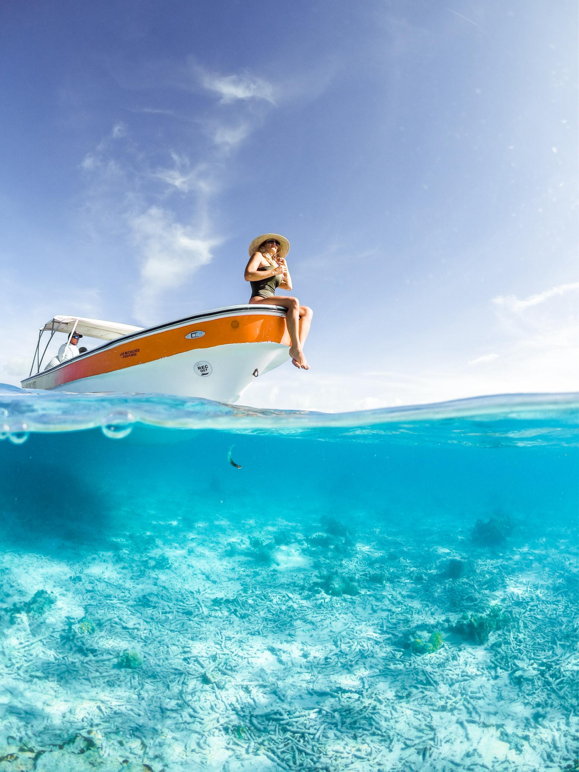 A woman sitting on the front of a boat
