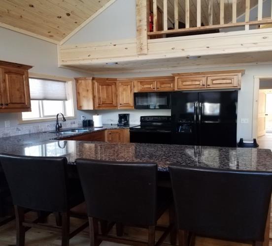 Kitchen with chairs and refrigerator