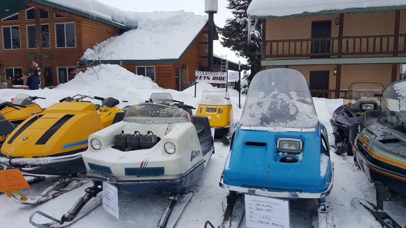 Snowmobiles lined up outside a motel room