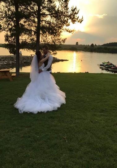 Newly wedded couple dancing during a sunset