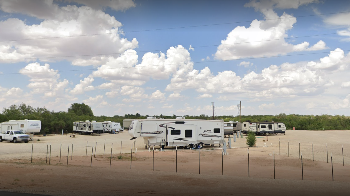 Caravans stored in rows on a sunny day.