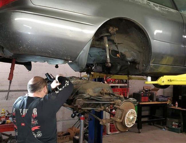 mechanic repairing an axle mechanic repairing an axle