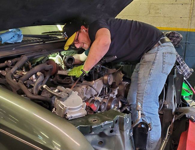 mechanic repairing an engine mechanic repairing an engine