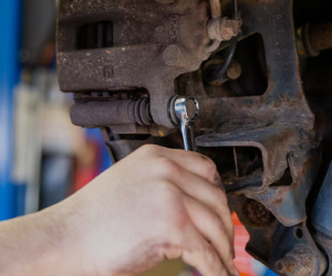 Our Technician is Working on a Brake Caliper - Protech Auto Group Inc.