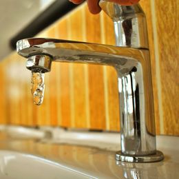 a faucet with a drop of water coming out of it