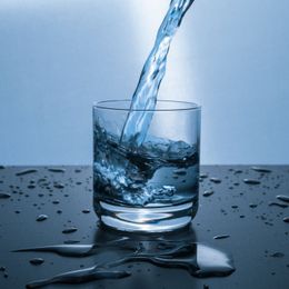a glass of water is being poured into it