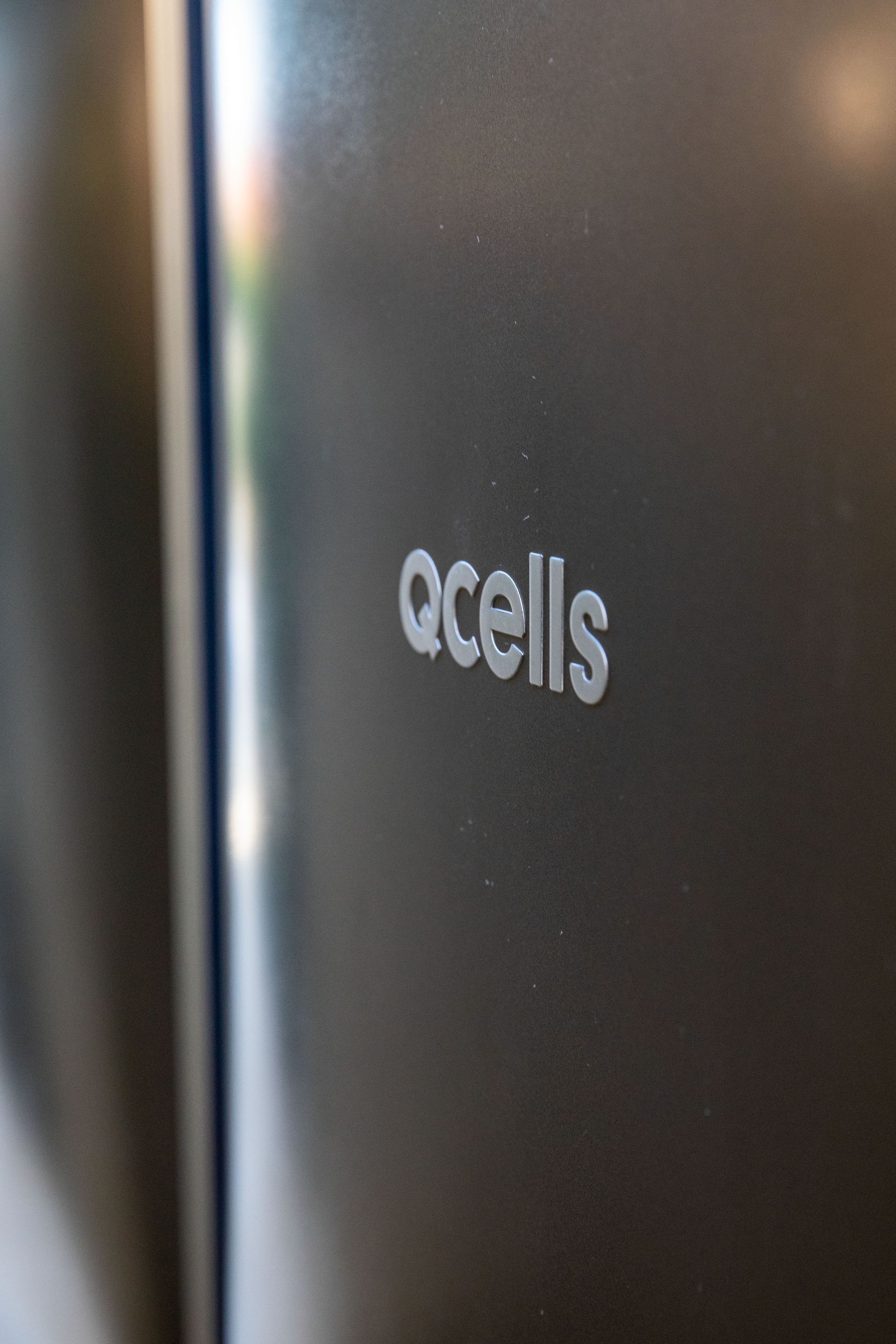 A close up of a cell phone that says qcells on it
