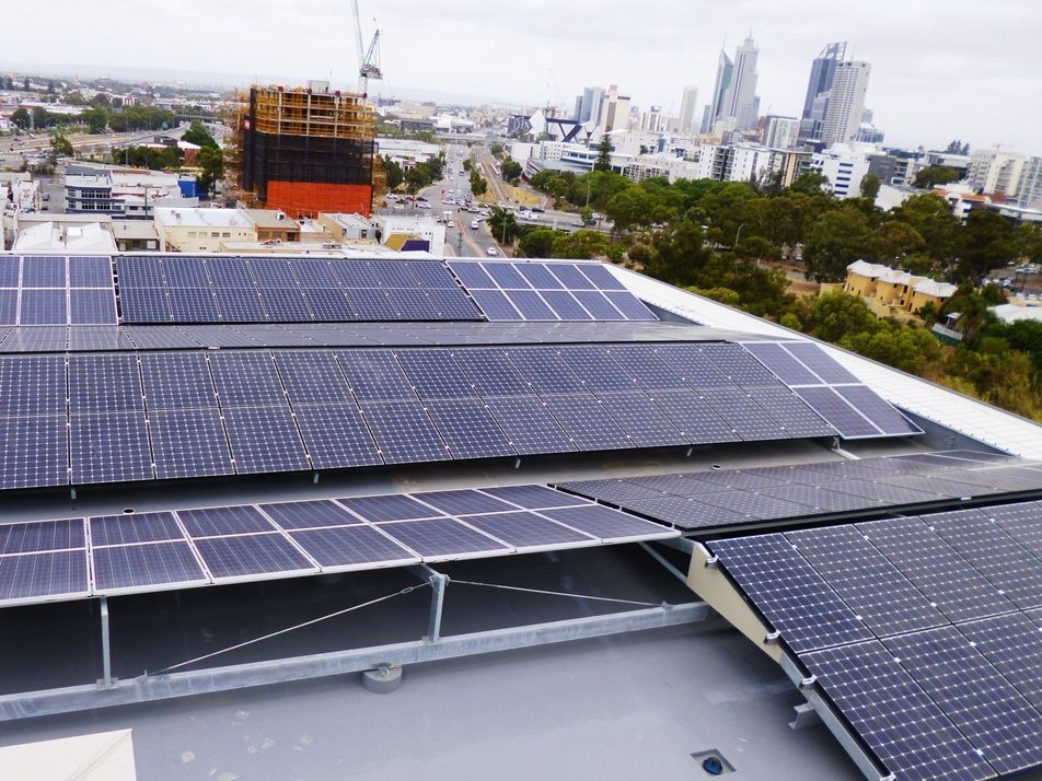 A bunch of solar panels on the roof of a building