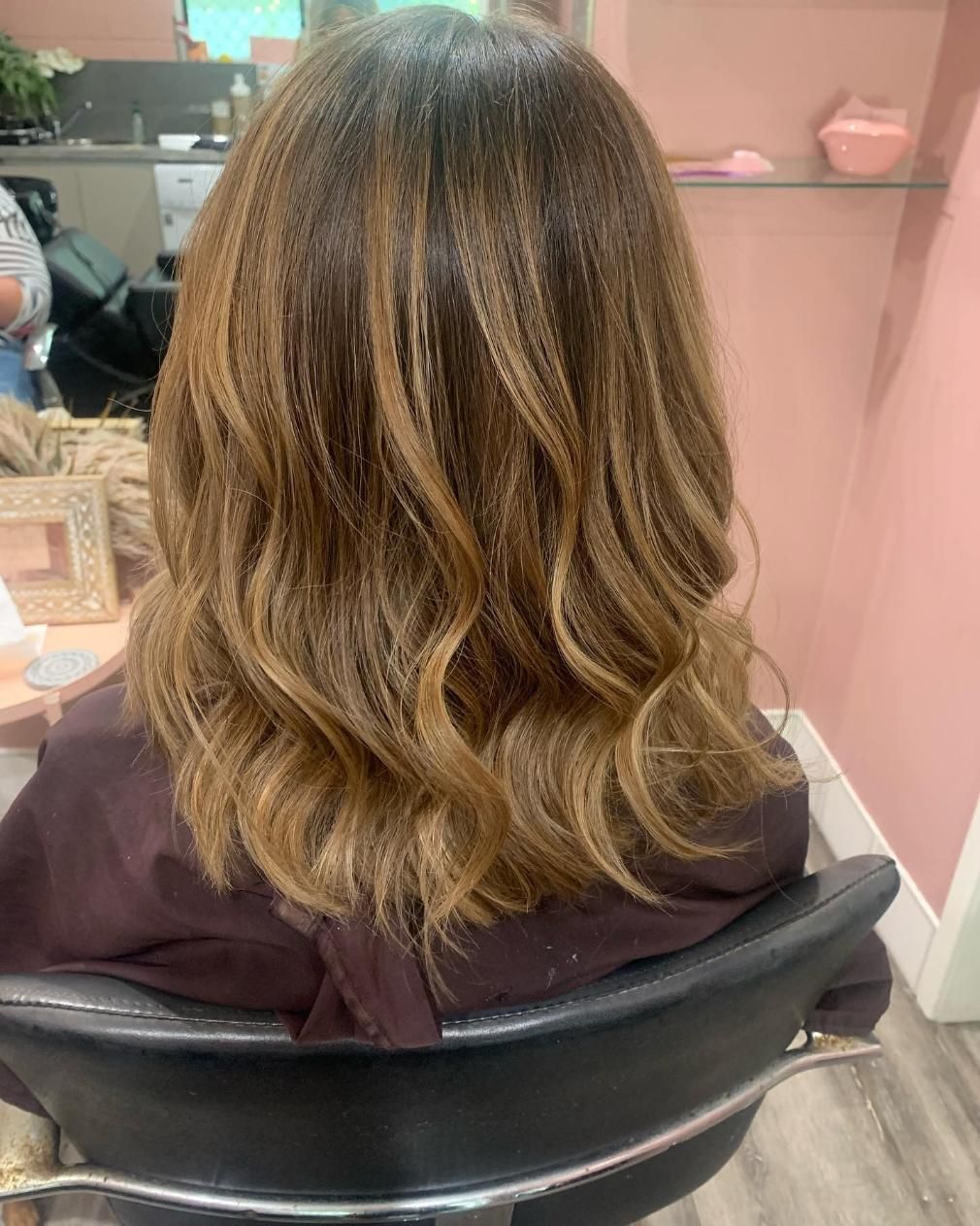 A Woman is Sitting in a Chair With Her Hair in a Salon — Hair By Jell In Cannonvale, QLD