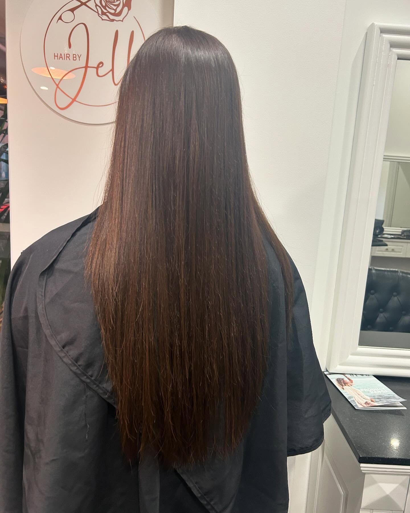 A Woman With Long Blonde Hair is Wearing a White Shirt and Smiling — Hair By Jell In Cannonvale, QLD
