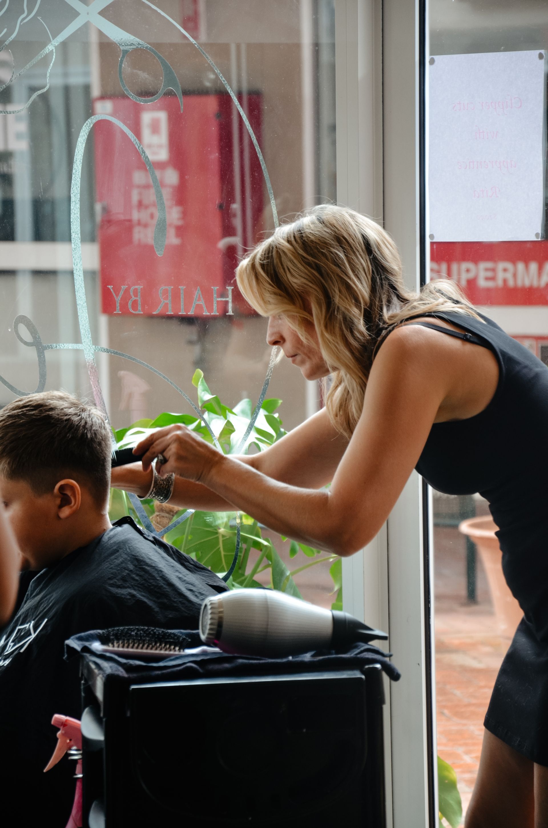 A Man With a Beard is Getting His Hair Cut by a Barber — Hair By Jell In Cannonvale, QLD