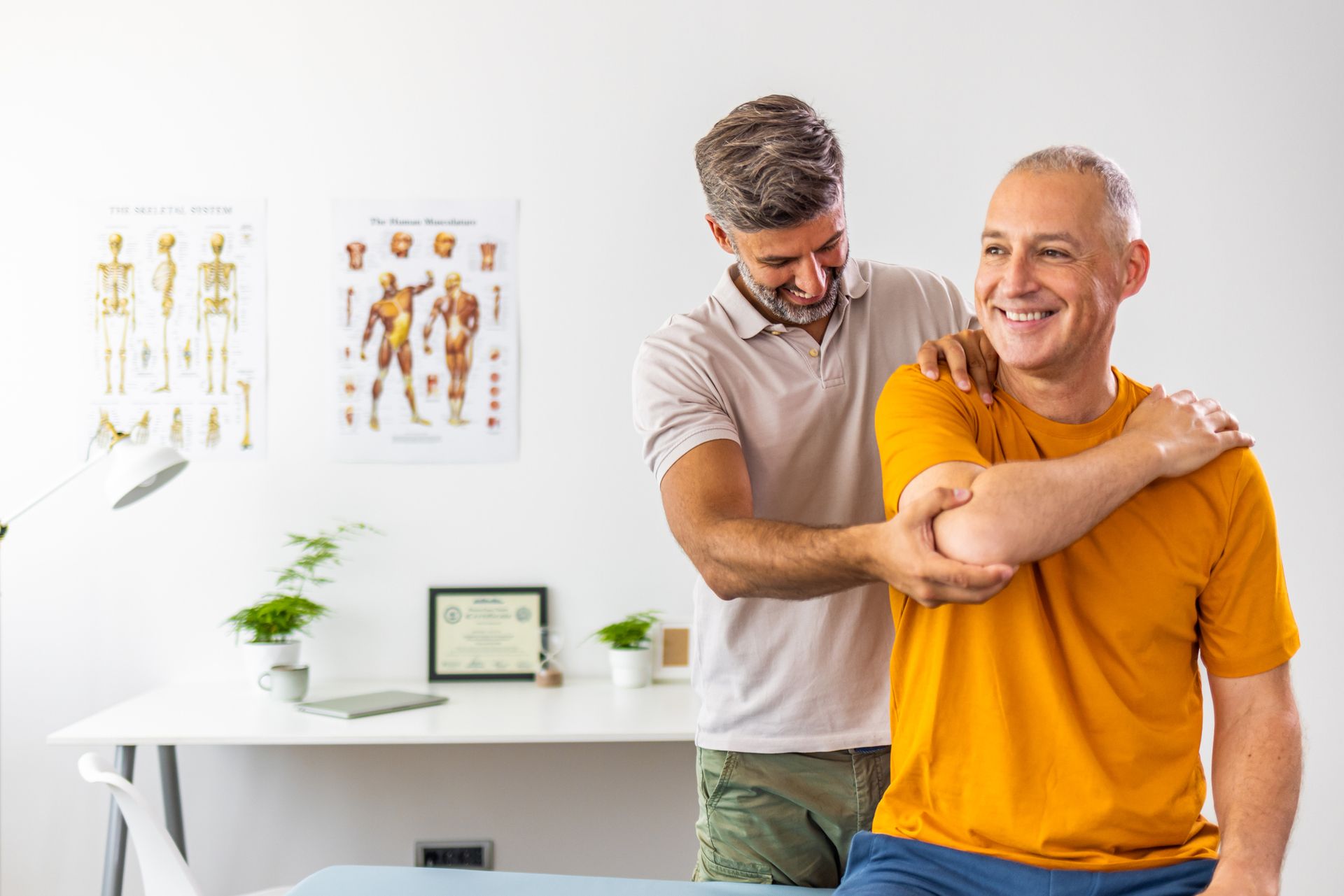 A man is getting his shoulder examined by a doctor.