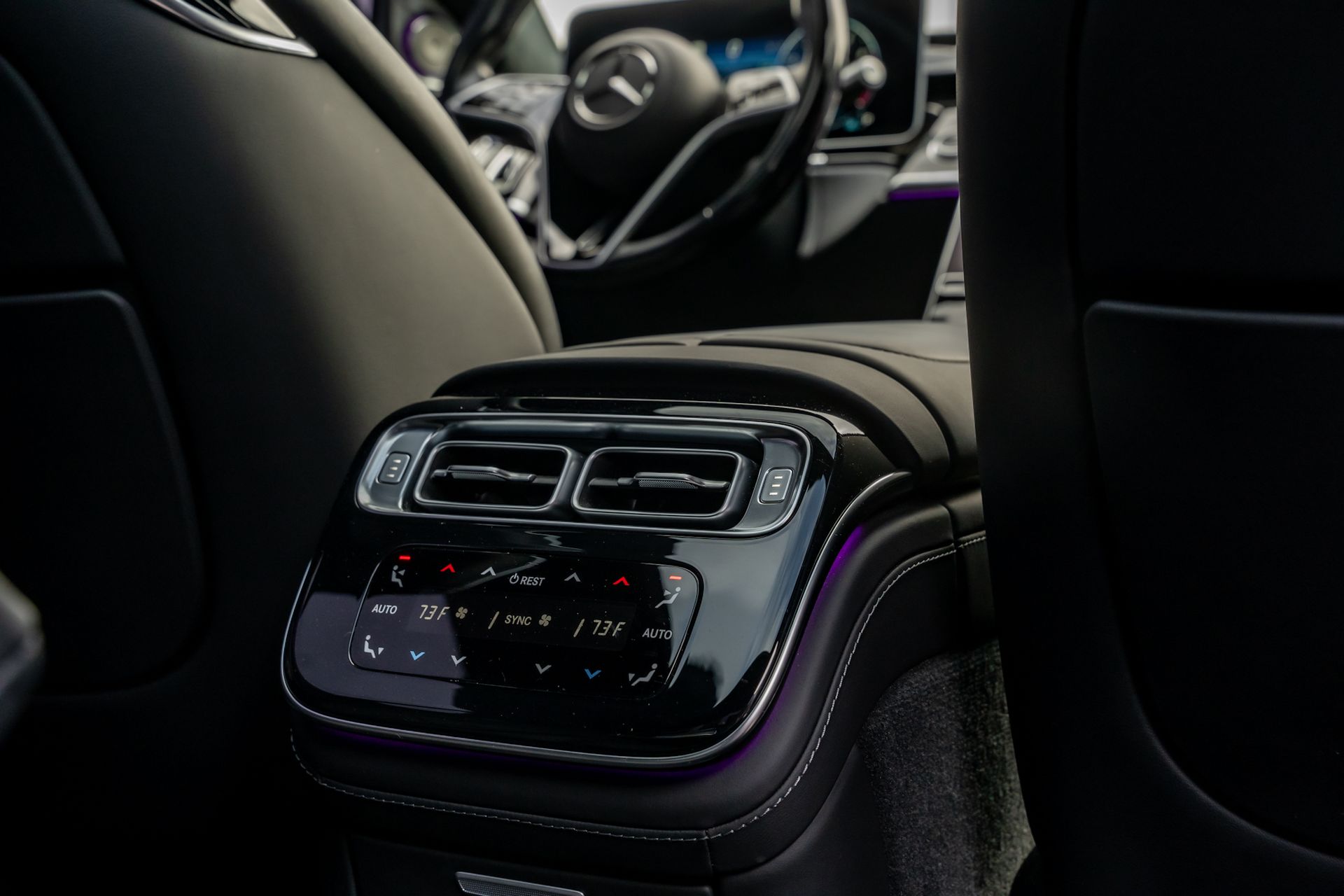 Interior car console with air vents and climate control buttons.
