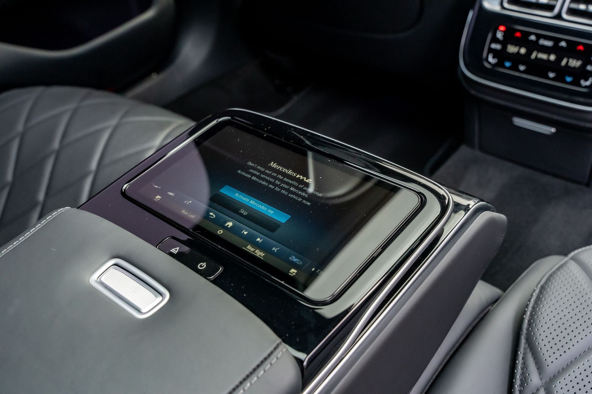 Center console with touchscreen display in a luxury car interior.
