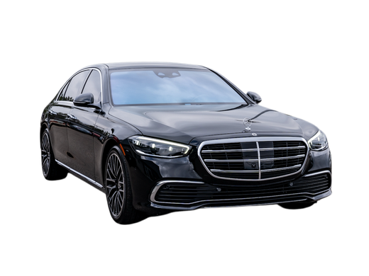 Black Mercedes-Benz sedan, parked outdoors, angled view.