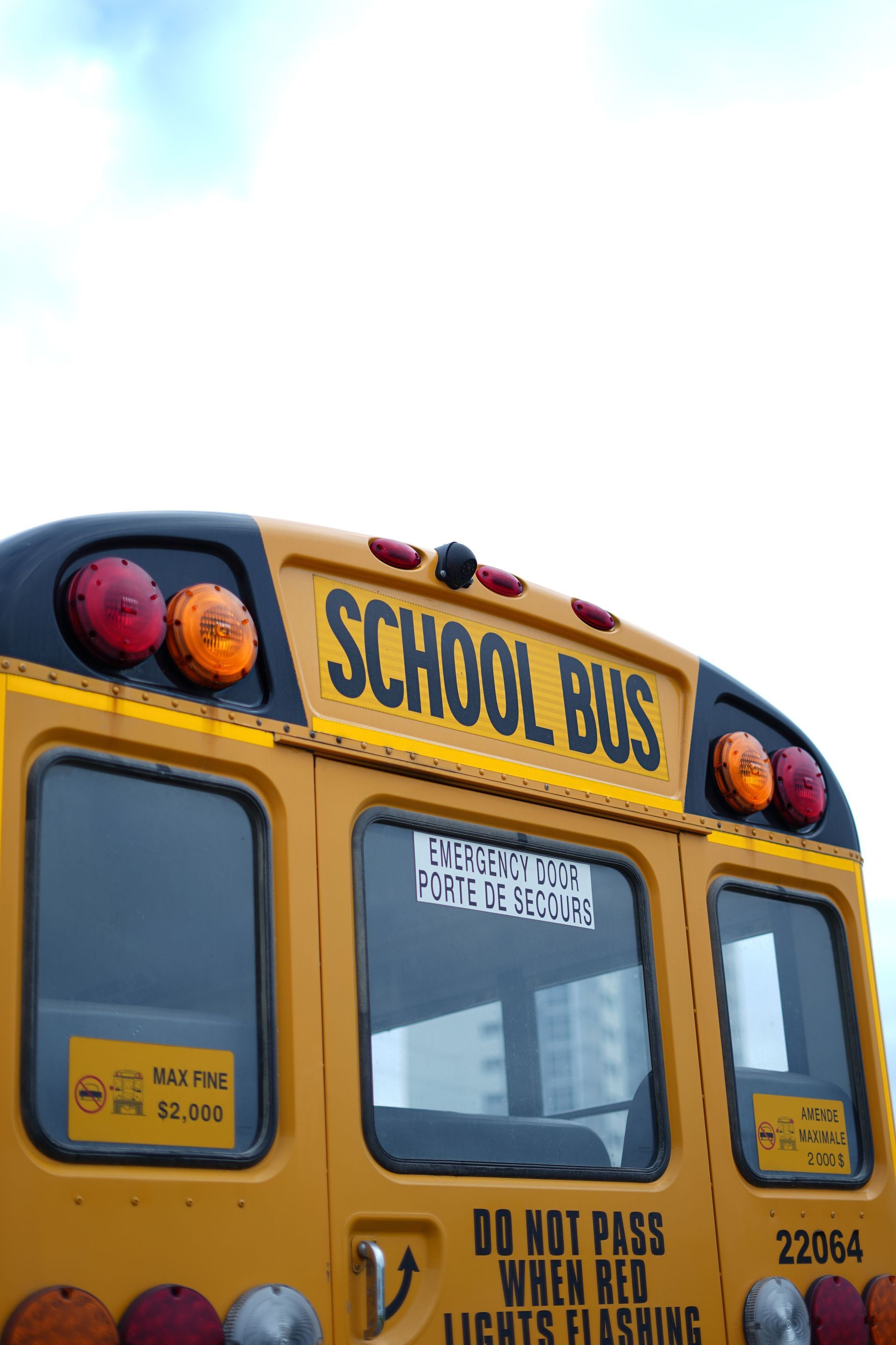 the back of the exterior of a yellow school bus