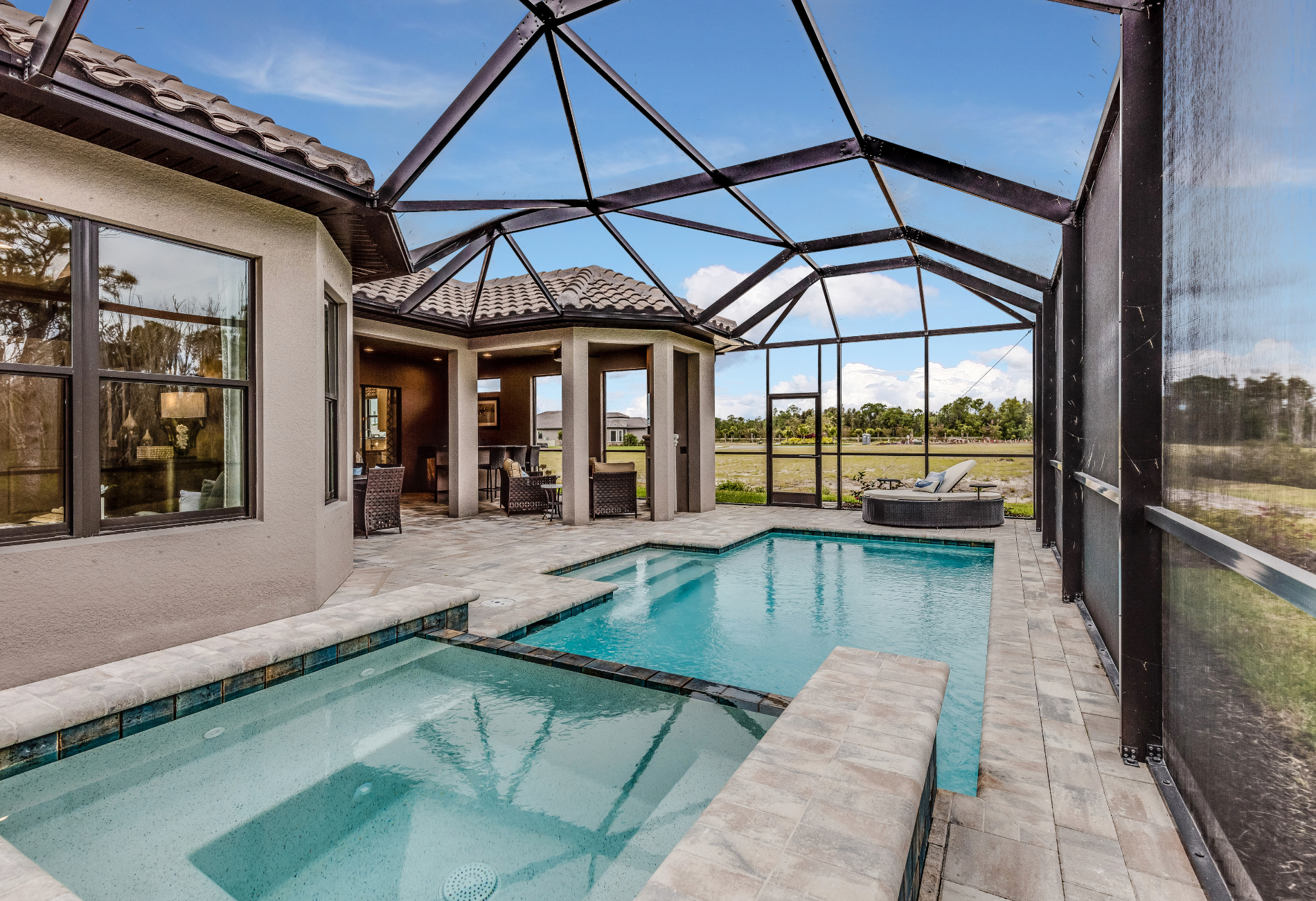 there is a large swimming pool in the backyard of a house .