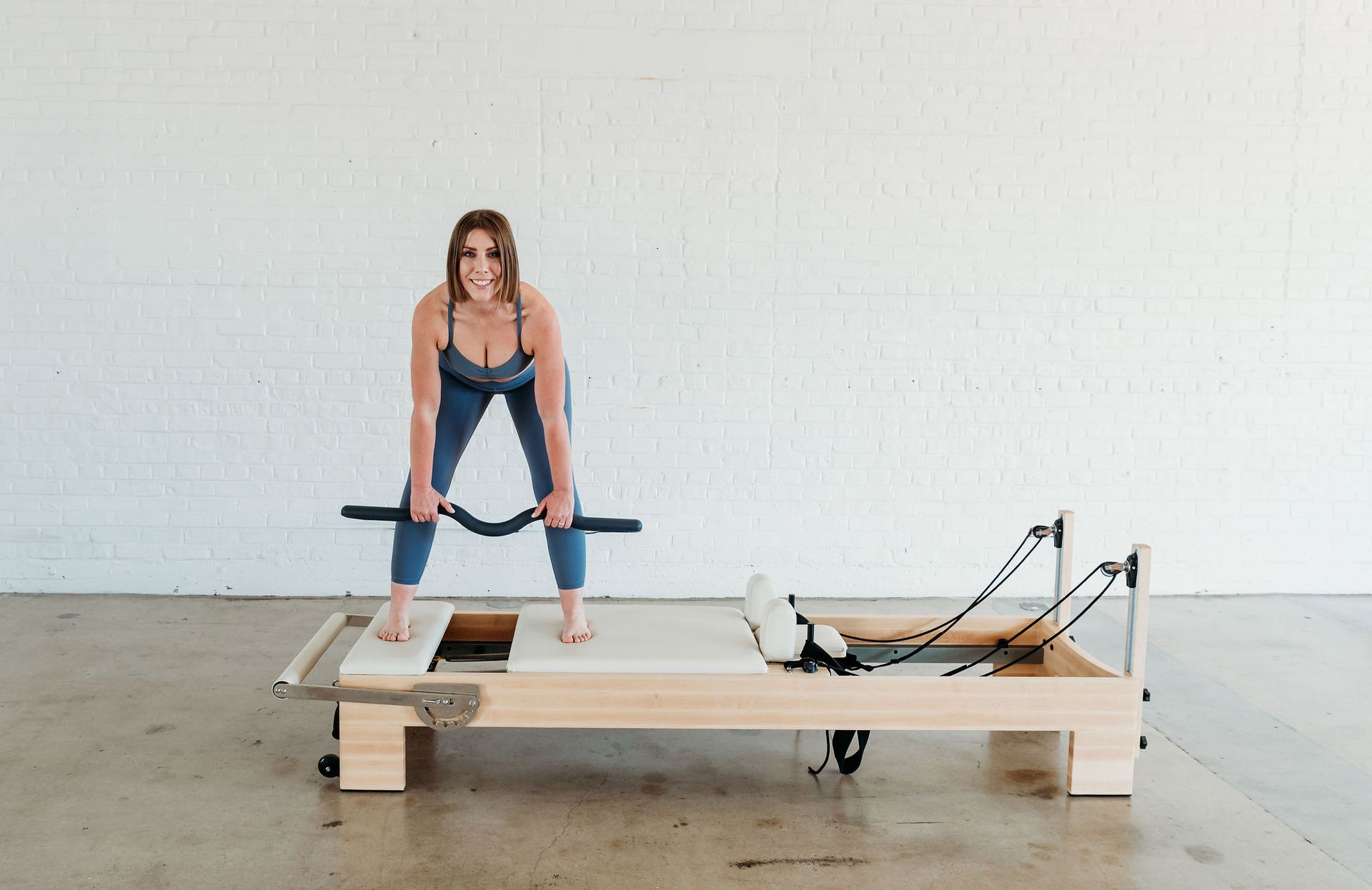 Erin Soler, owner of Pilates Mariposa, demonstrating a move from their Strength class