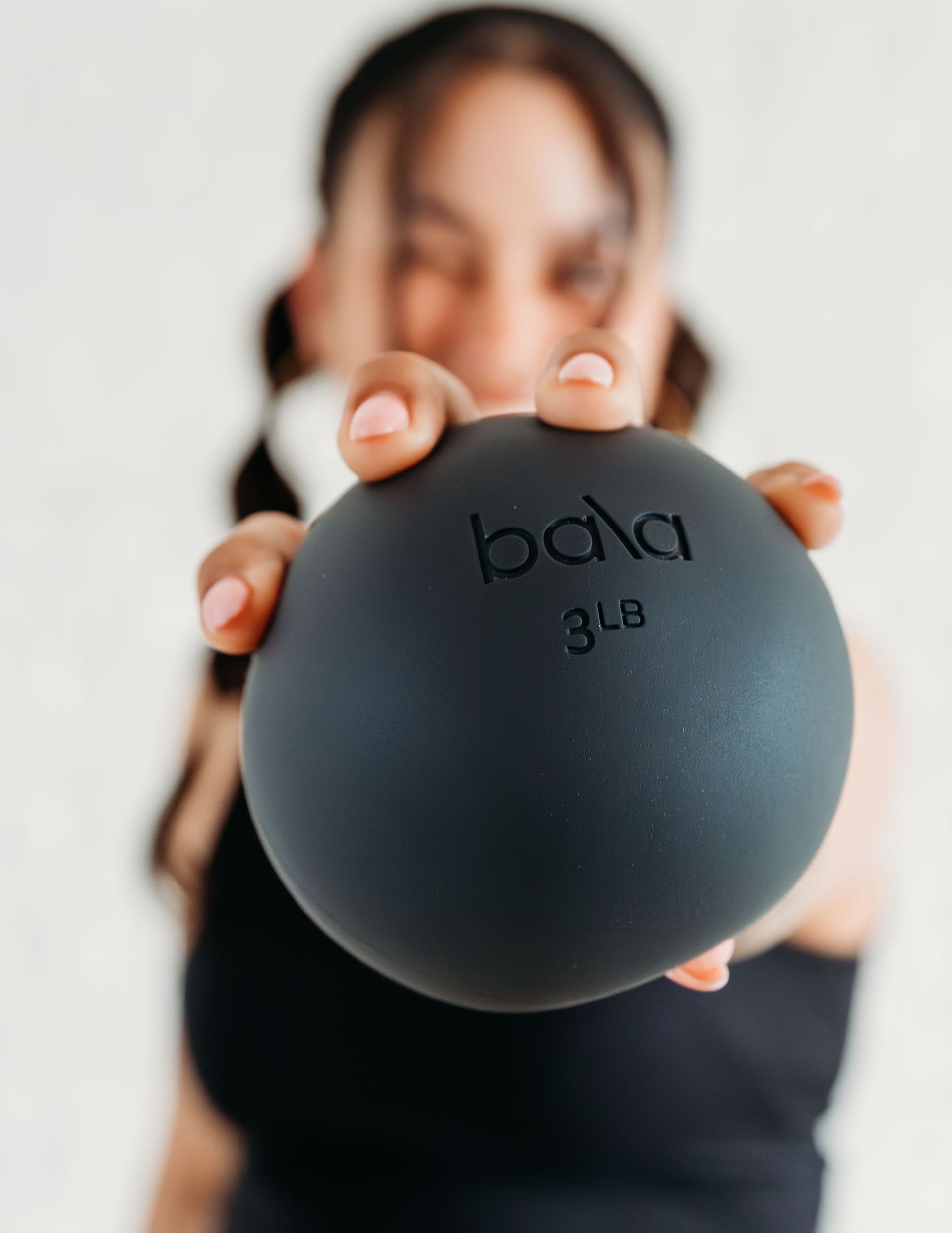 Jacque, an instructor at Pilates Mariposa, showing off our Bala props