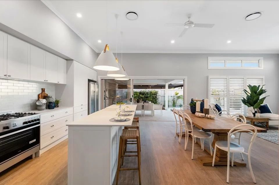 A Kitchen With A Long Island And A Dining Table — Norm Evans Floors Pty Ltd in Kunda Park, QLD
