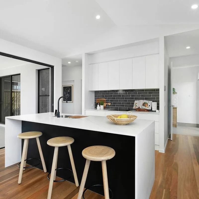 A Kitchen With A Large Island And Three Stools — Norm Evans Floors Pty Ltd in Kunda Park, QLD
