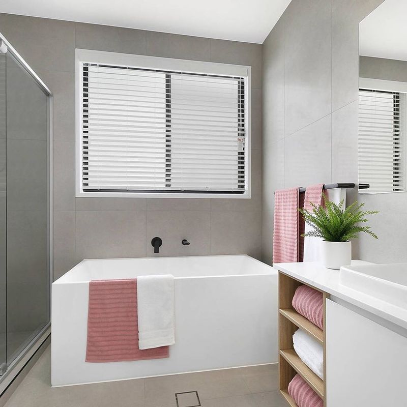A Bathroom With A Bathtub , Sink , Mirror And Window — Norm Evans Floors Pty Ltd in Kunda Park, QLD