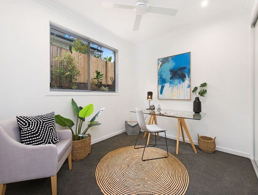 A Living Room With A Couch , Chairs , And A Table — Norm Evans Floors Pty Ltd in Kunda Park, QLD