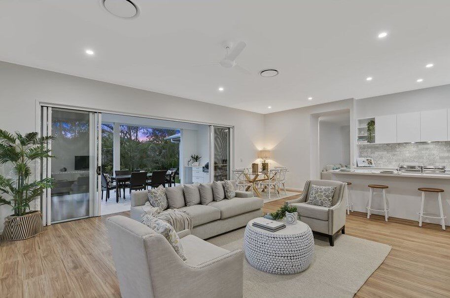 There Is A Dining Table And Chairs On The Patio Of A House — Norm Evans Floors Pty Ltd in Kunda Park, QLD