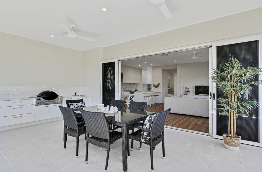 There Is A Dining Table And Chairs On The Patio Of A House — Norm Evans Floors Pty Ltd in Kunda Park, QLD