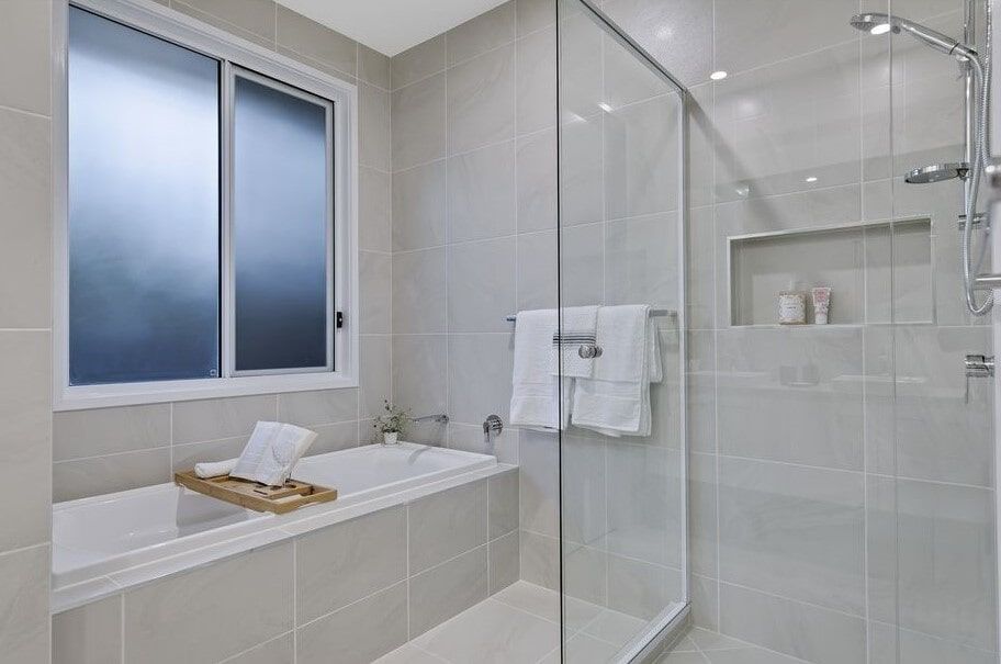 A Bathroom With A Bathtub And A Walk In Shower — Norm Evans Floors Pty Ltd in Kunda Park, QLD