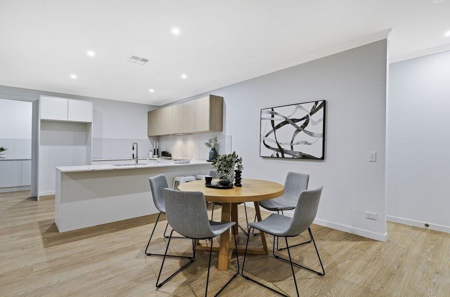 A Dining Room With A Table And Chairs In A Kitchen — Norm Evans Floors Pty Ltd in Kunda Park, QLD
