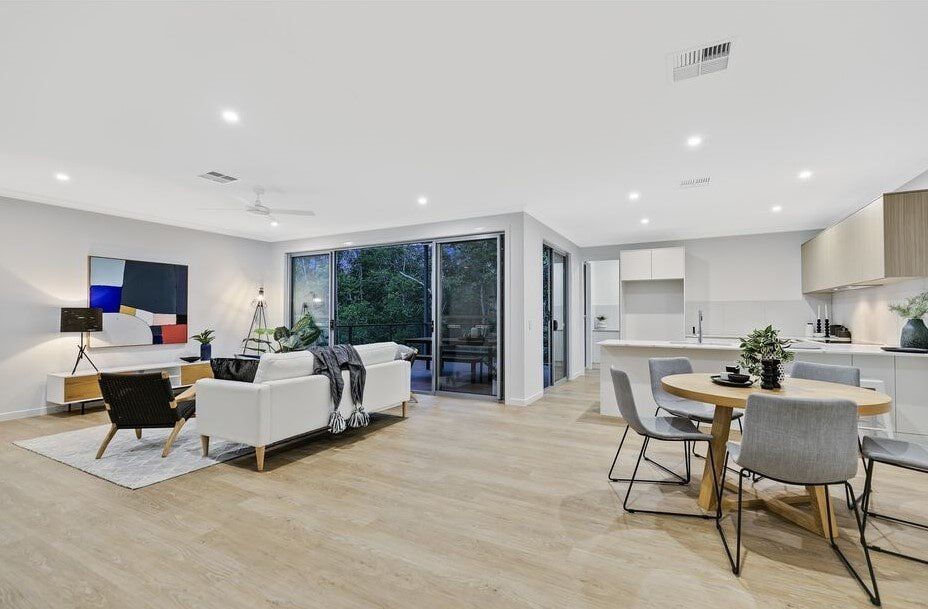 A Living Room And Dining Room In A House With A Table And Chairs — Norm Evans Floors Pty Ltd in Kunda Park, QLD