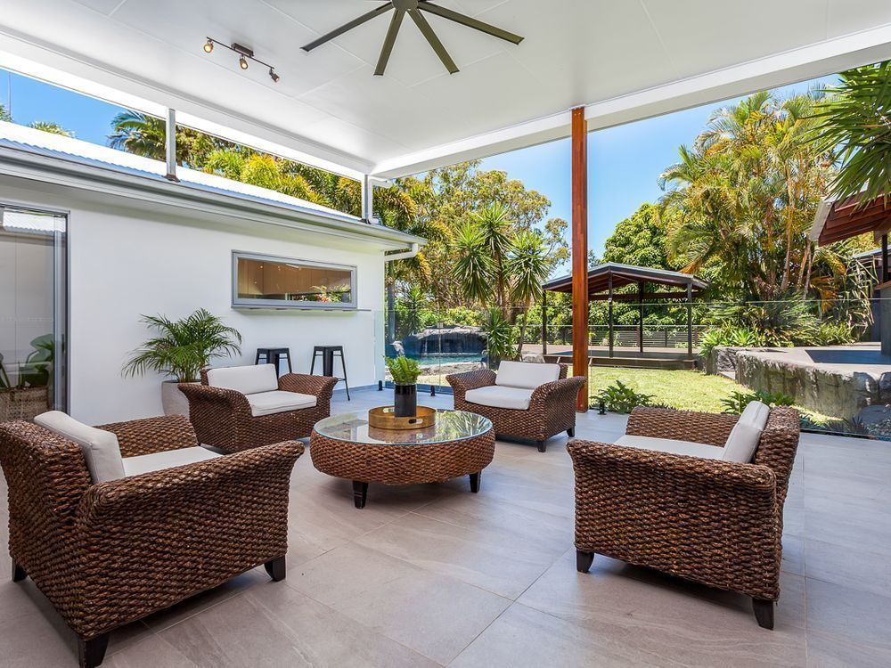 A Patio With Chairs , A Table And A Ceiling Fan — Norm Evans Floors Pty Ltd in Kunda Park, QLD