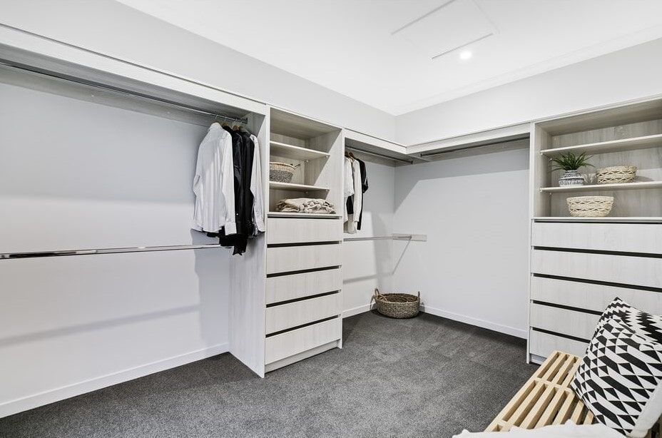 A Bedroom With A Bed , Nightstand , Chair And Window — Norm Evans Floors Pty Ltd in Kunda Park, QLD