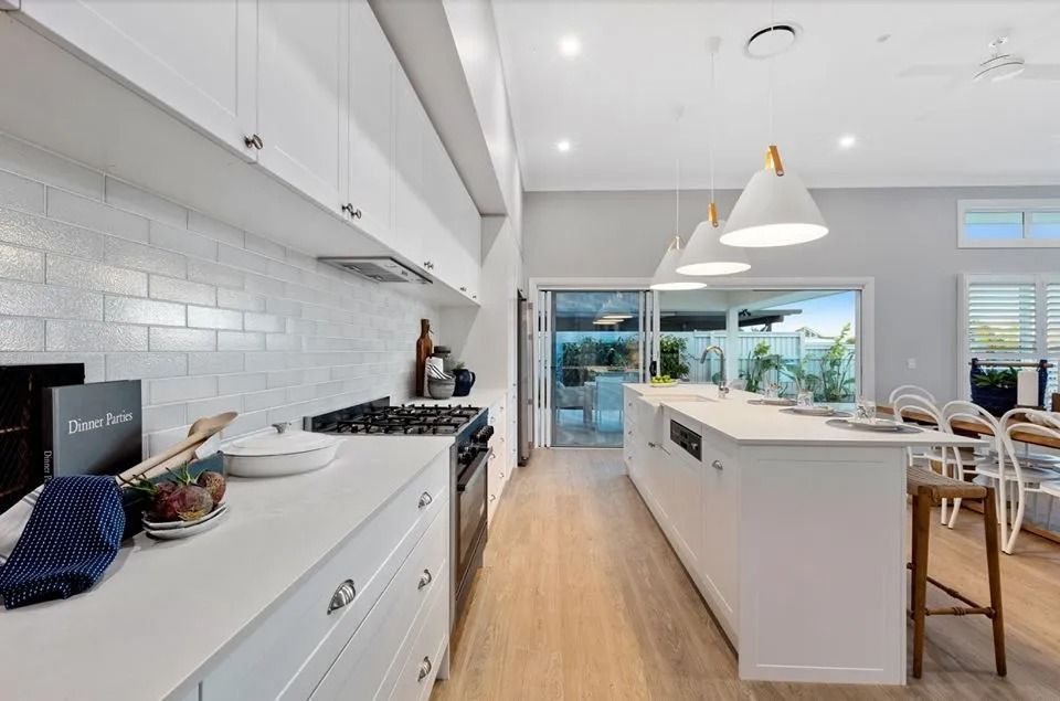 A Kitchen With White Cabinets , Stainless Steel Appliances — Norm Evans Floors Pty Ltd in Kunda Park, QLD