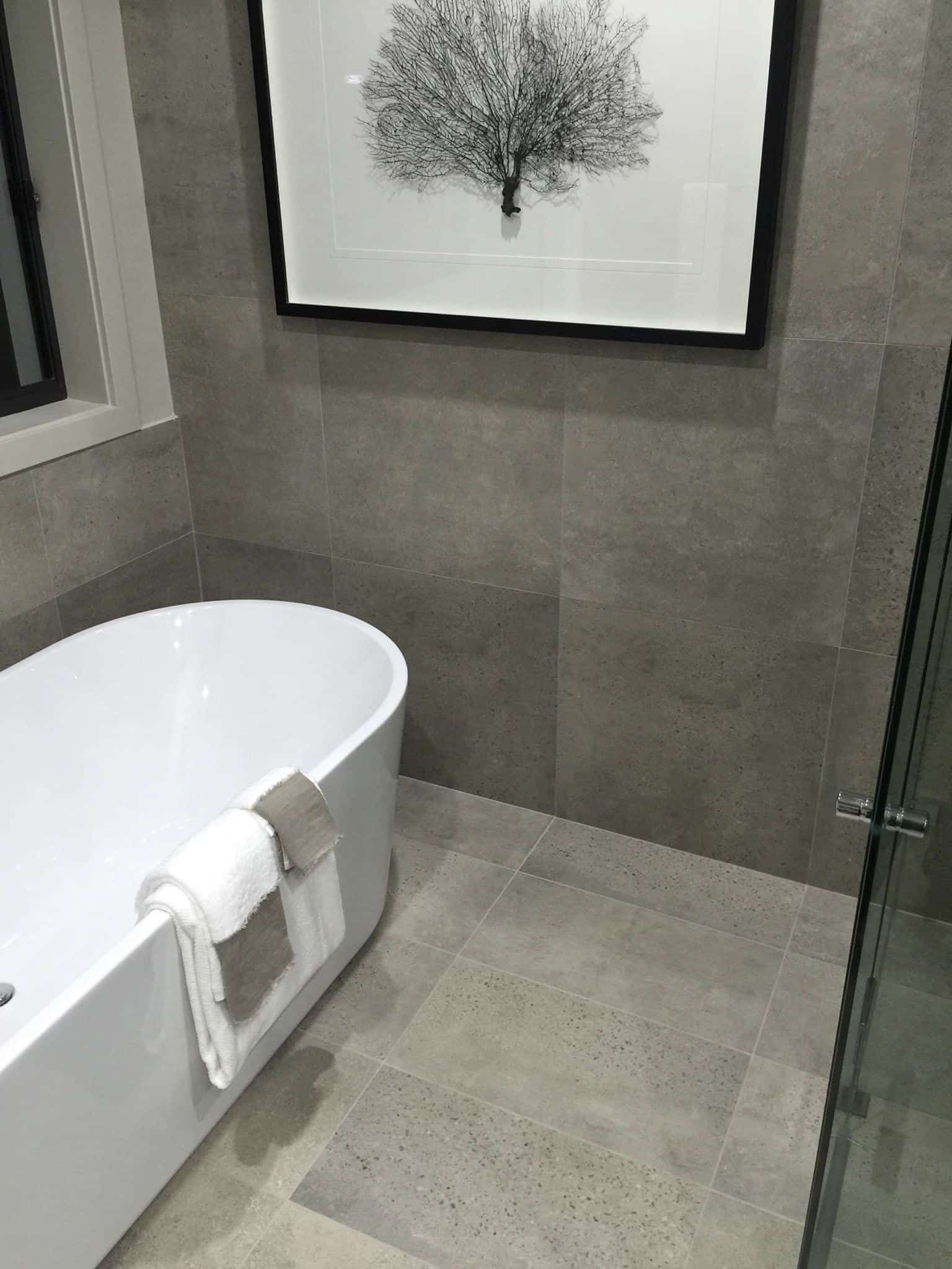 Tidy bathroom with a towel-draped bathtub — Corrimal Discount Tiles and Bathroomwear in East Corrimal, NSW