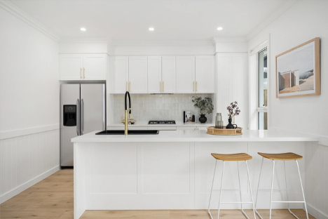 A Kitchen with White Cabinets, Stools, A Refrigerator and A Sink — Corrimal Discount Tiles and Bathroomwear in East Corrimal, NSW