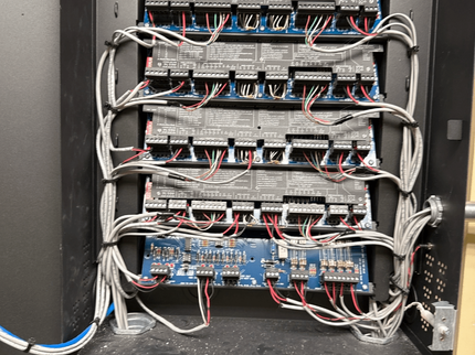 Open network rack with neatly bundled cables and stacked routers/switches inside a cabinet.