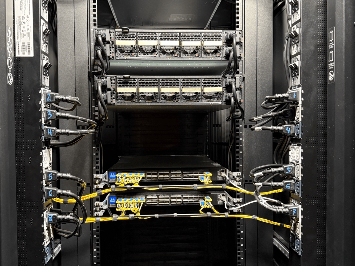 Server rack with networking equipment, cables, and switches in a data center.